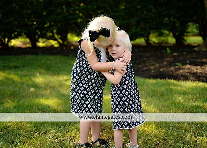 mechanicsburg-central-pa-family-portrait-photographer-outdoor-father-mother-daughters-sisters-siblings-iron-bench-wooden-swing-wildflowers-grass-holding-hands-hug-kw-05