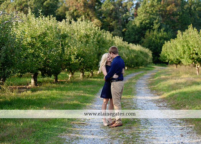 mechanicsburg-central-pa-engagement-portrait-photographer-outdoor-couple-orchard-road-path-trees-holding-hands-kiss-hug-love-barn-field-wildflowers-ls-01