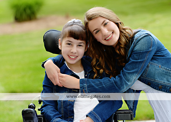 Mechanicsburg Central PA family portrait photographer outdoor children daughters sisters mother father grass trees road wheelchair hug kiss dk 05