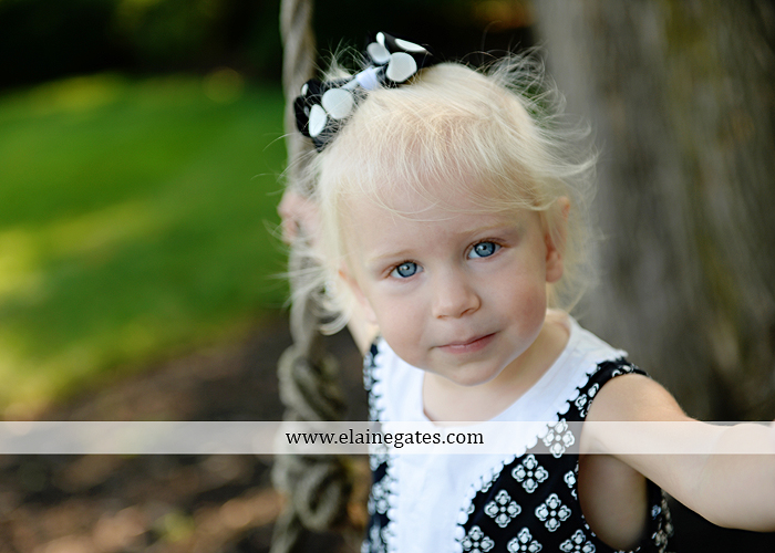 mechanicsburg-central-pa-family-portrait-photographer-outdoor-father-mother-daughters-sisters-siblings-iron-bench-wooden-swing-wildflowers-grass-holding-hands-hug-kw-03