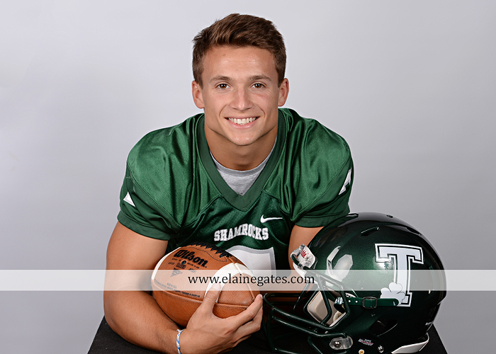 Mechanicsburg Central PA senior portrait photographer indoor guy male formal suit football player helmet jersey trinity cb 2